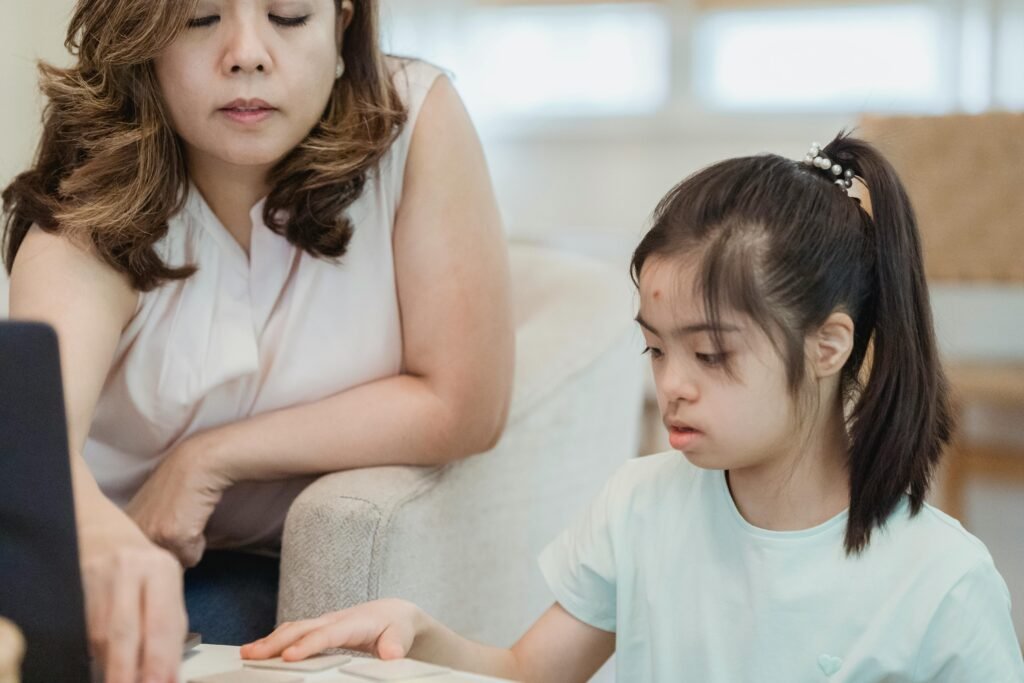 A mother and daughter focus on a task together, displaying family bonding.