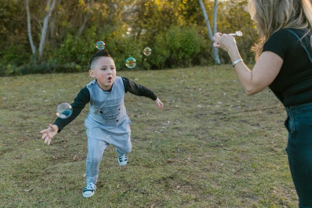 Preschool child playfully testing boundaries with a parent in a playful scene