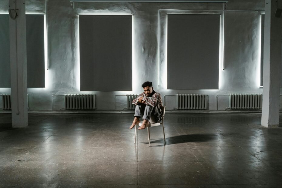 An anxious child sitting alone in the corner feeling worried