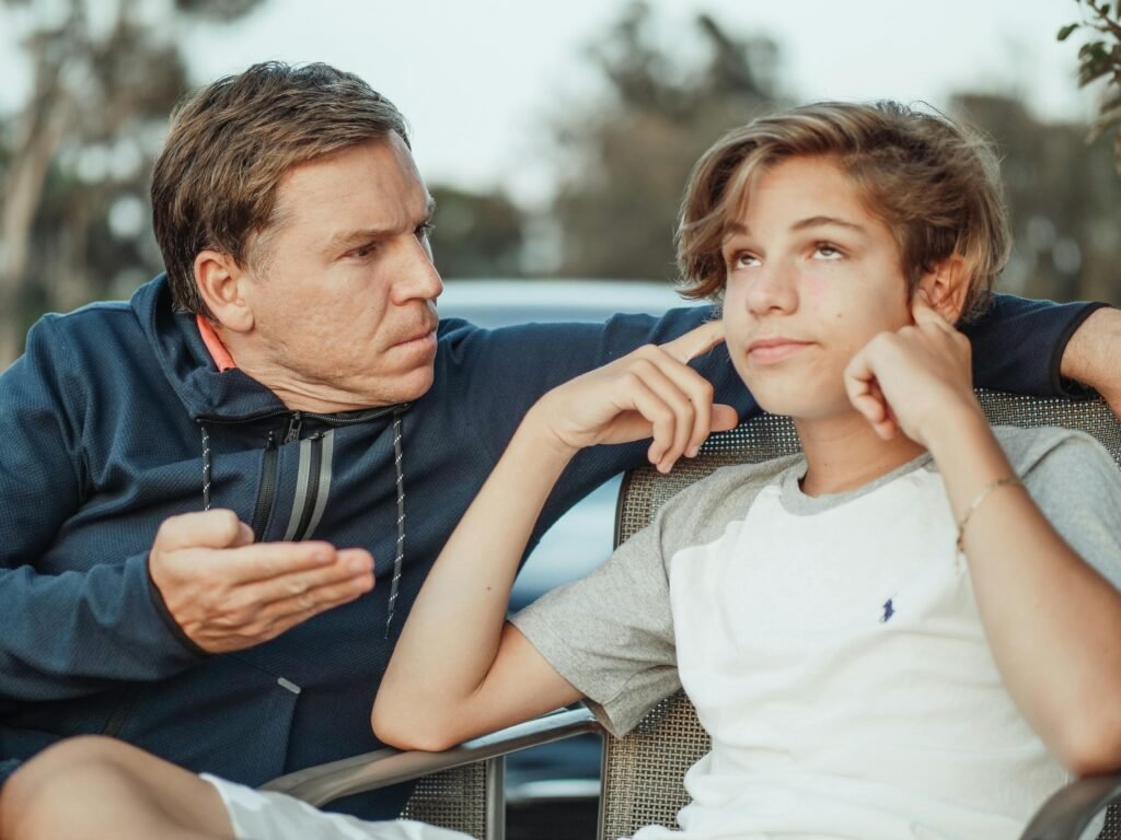 Frustrated parent talking to child who’s ignoring them in a cozy living room setting